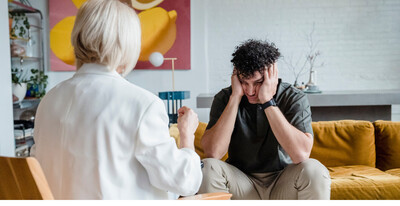 Person sitting with another person